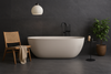 Slab tegel Newstone Dark 100x300 cm verwerkt in een minimalistische woonkamer met een tegel zonder voeg voor een strak en ruimtelijk effect.